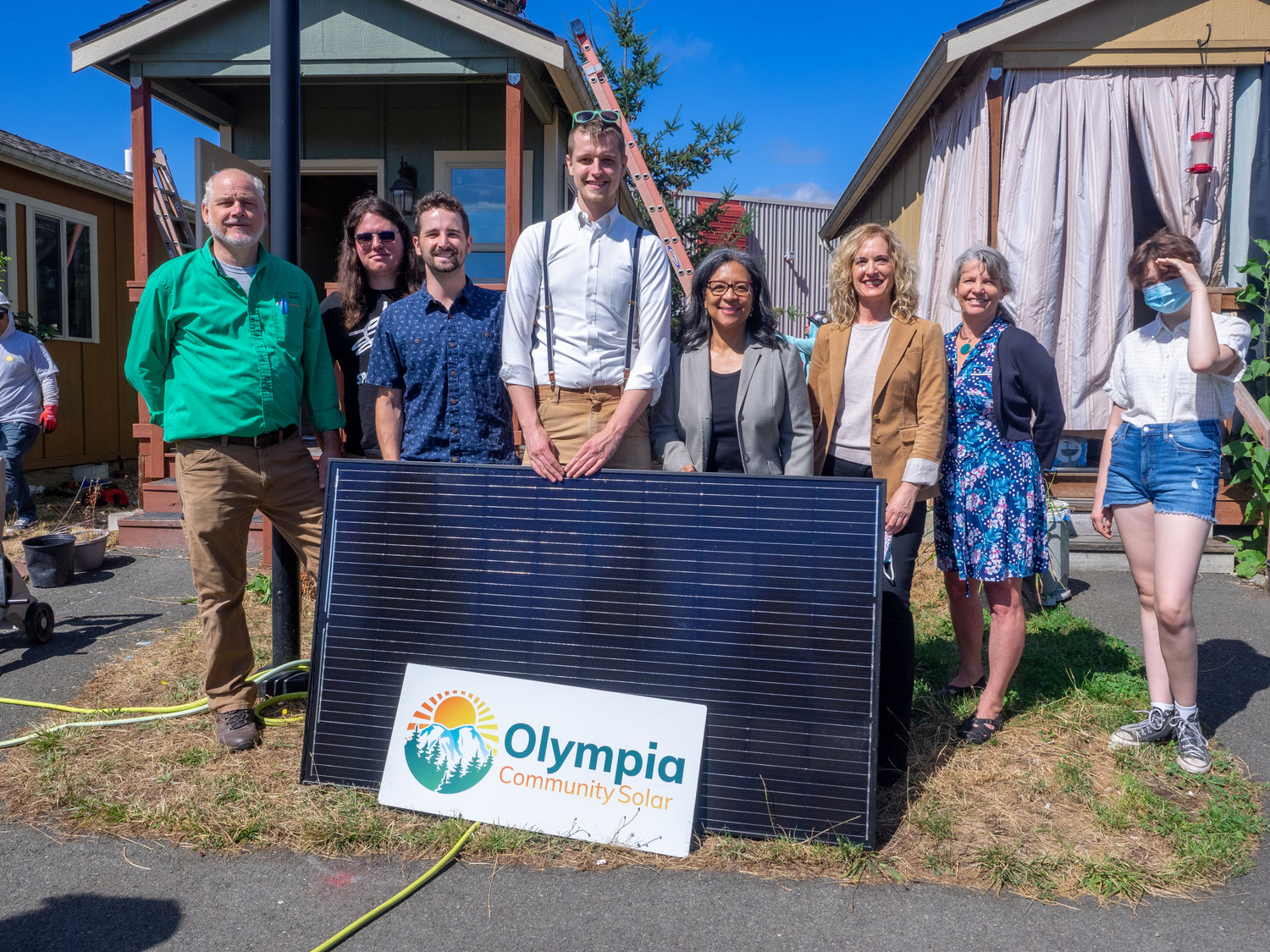 Standing with one of the solar panels about to be installed at the Quixote Village, are Congresswoman Marilyn Strickland, the leaders of the Olympia Community Solar, Quixote Village, and South Sound Solar.